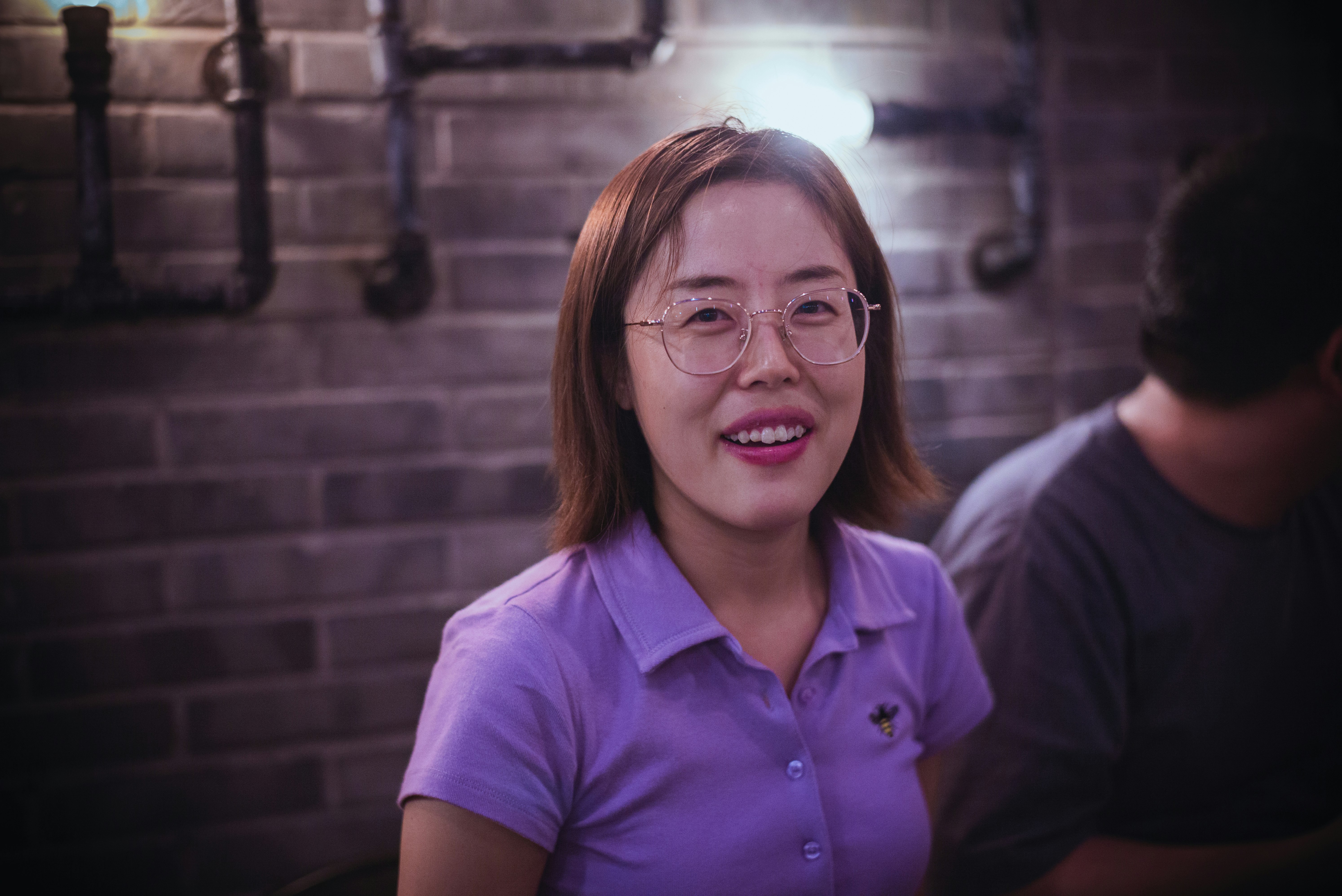 woman in purple polo shirt smiling